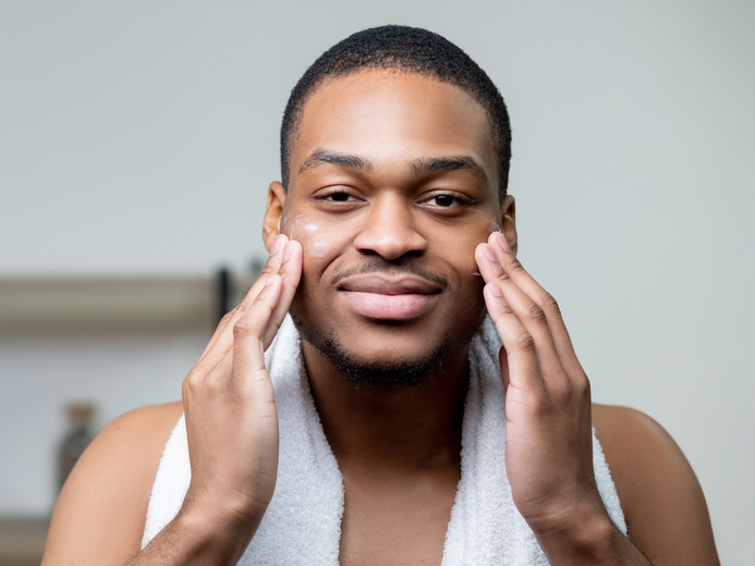 man facial care skin moisturizing applying cream