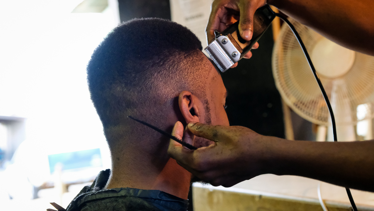 Barber cutting his clients hair